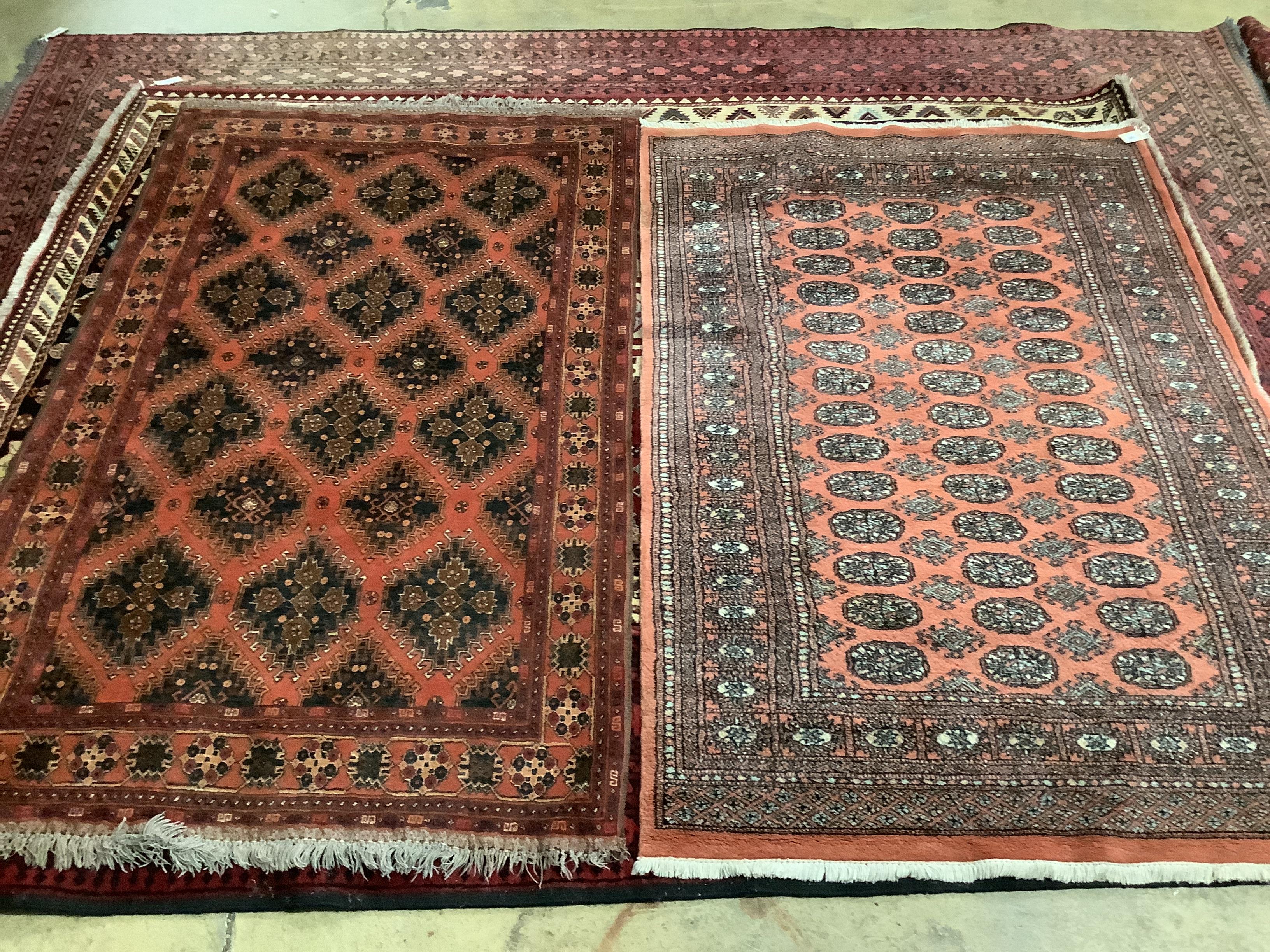 A Caucasian brick red ground rug, 196 x 120cm and a cotton pile Bokhara rug, 193 x 128cm